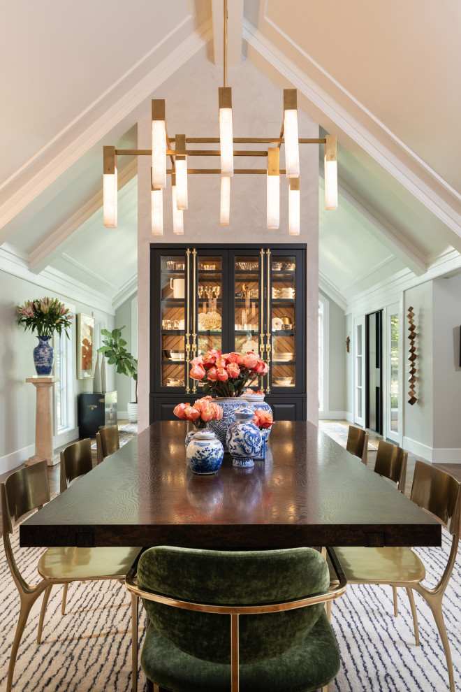 Example of a large classic medium tone wood floor, brown floor and vaulted ceiling dining room design in Other