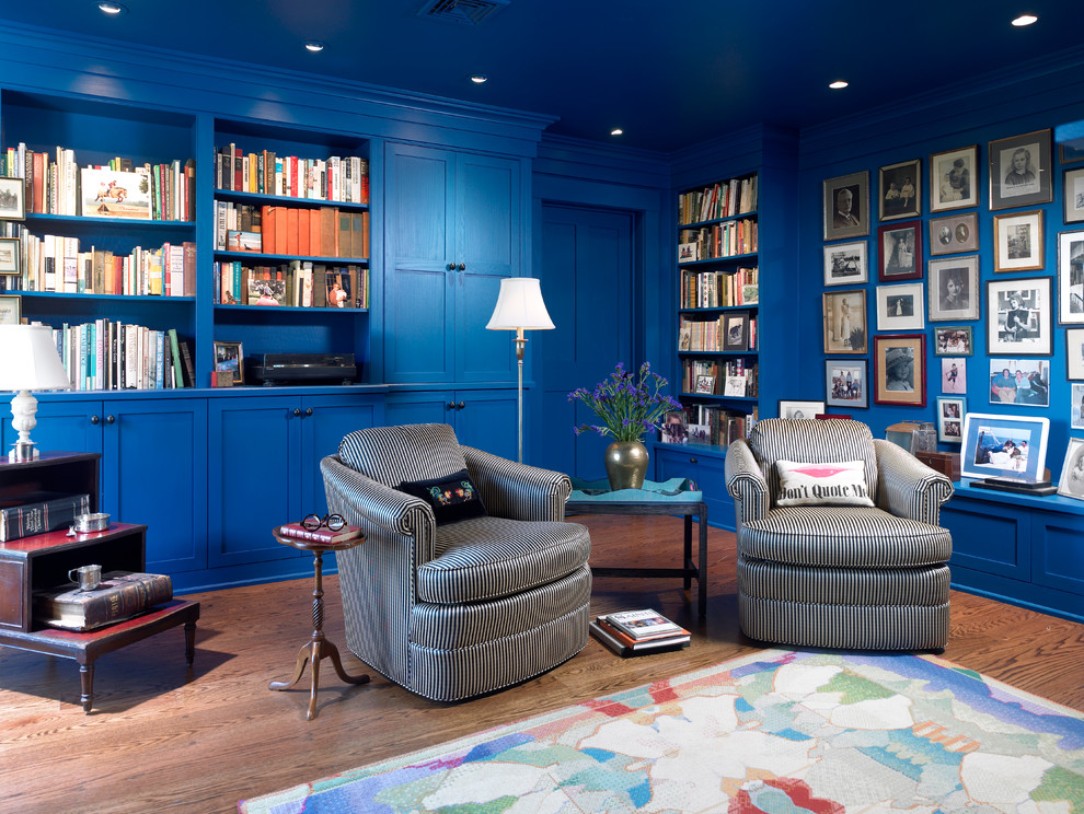 Design ideas for a modern living room in Philadelphia with a library, blue walls and medium hardwood floors.