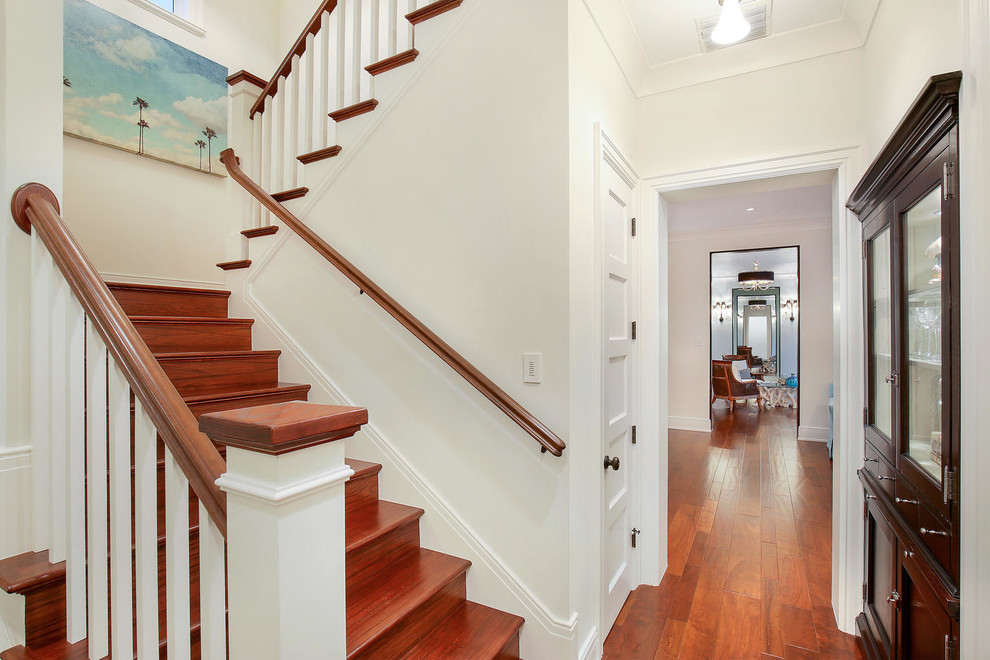 This is an example of a mid-sized tropical wood l-shaped staircase in Tampa with wood risers.