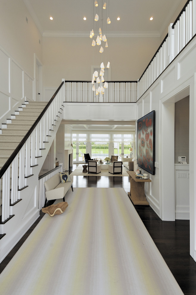 Design ideas for a transitional foyer in Los Angeles with white walls and dark hardwood floors.