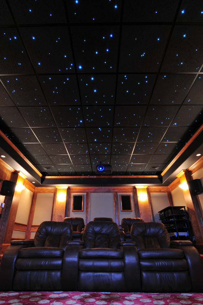 Photo of a large traditional enclosed home theatre in Cleveland with carpet and a projector screen.