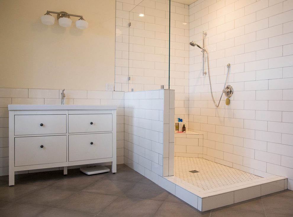 Photo of a mid-sized country 3/4 bathroom in San Francisco with flat-panel cabinets, white cabinets, a corner shower, white tile, subway tile, beige walls, concrete floors, an undermount sink, engineered quartz benchtops, brown floor and an open shower.