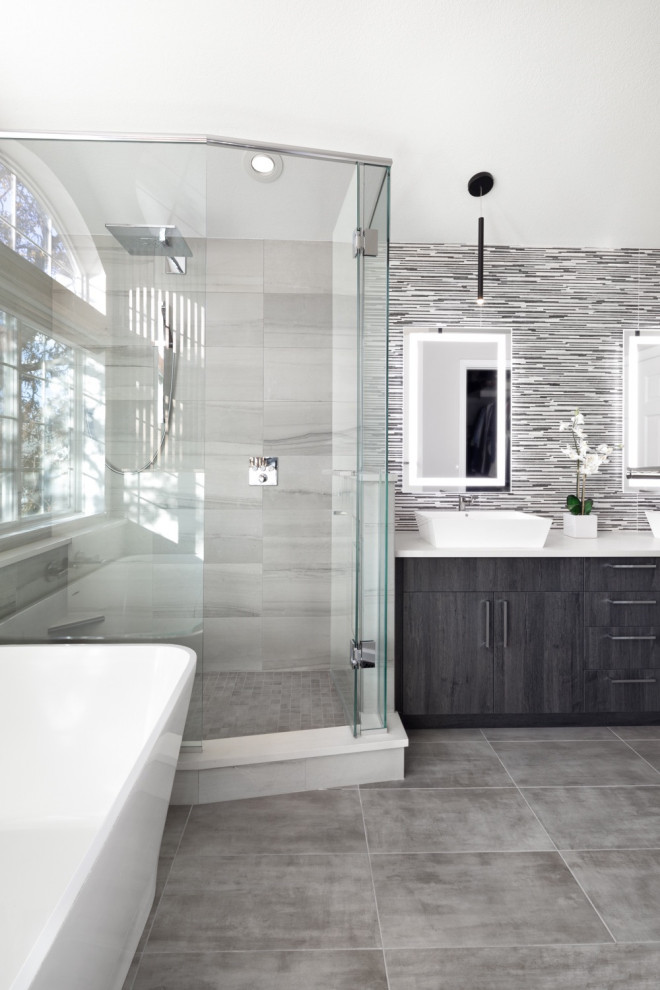 This is an example of a large contemporary master bathroom in Denver with flat-panel cabinets, white cabinets, a freestanding tub, an open shower, multi-coloured tile, white walls, slate floors, a vessel sink, quartzite benchtops, grey floor, a hinged shower door, white benchtops, a single vanity and a built-in vanity.