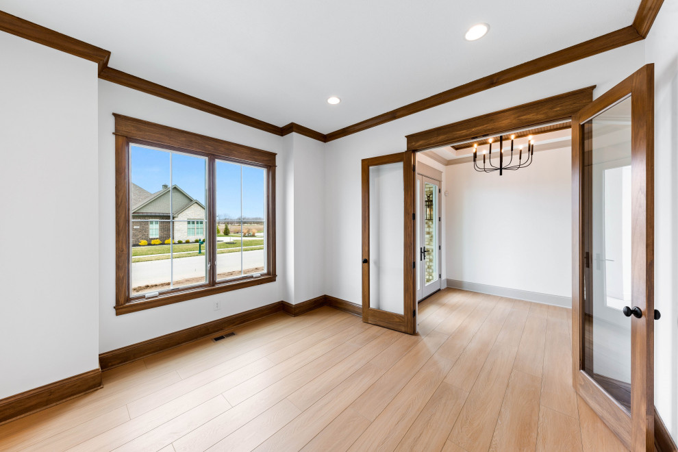 Inspiration for a large transitional vinyl floor, beige floor and wood wall home office remodel in Indianapolis with white walls