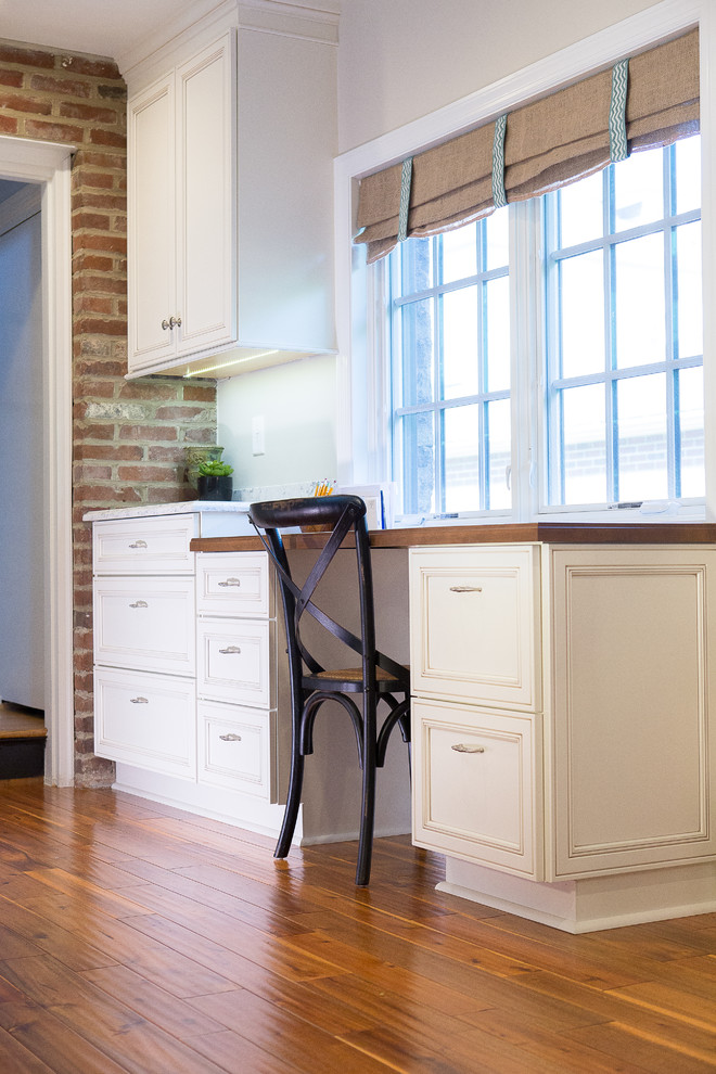 Inspiration for a large transitional medium tone wood floor eat-in kitchen remodel with an undermount sink, recessed-panel cabinets, black cabinets, quartz countertops, brick backsplash, stainless steel appliances and an island
