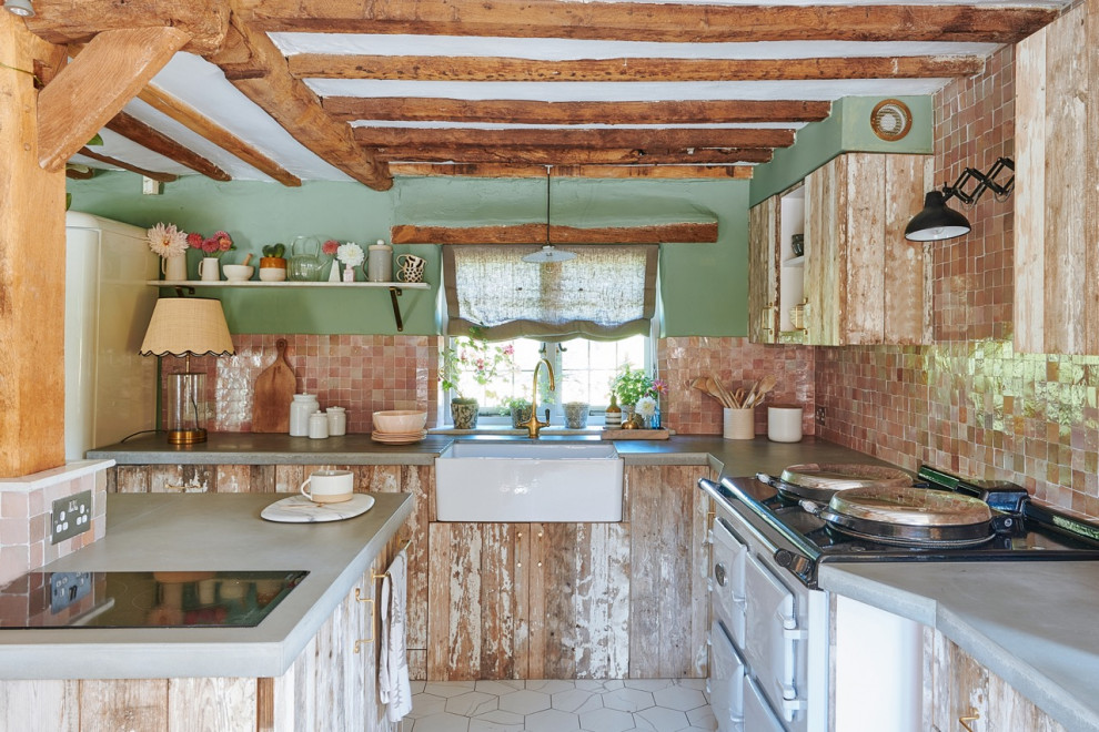 Inspiration for a mid-sized country eat-in kitchen in Hampshire with a farmhouse sink, flat-panel cabinets, light wood cabinets, concrete benchtops, pink splashback, ceramic splashback, panelled appliances, porcelain floors, with island, white floor, grey benchtop and exposed beam.