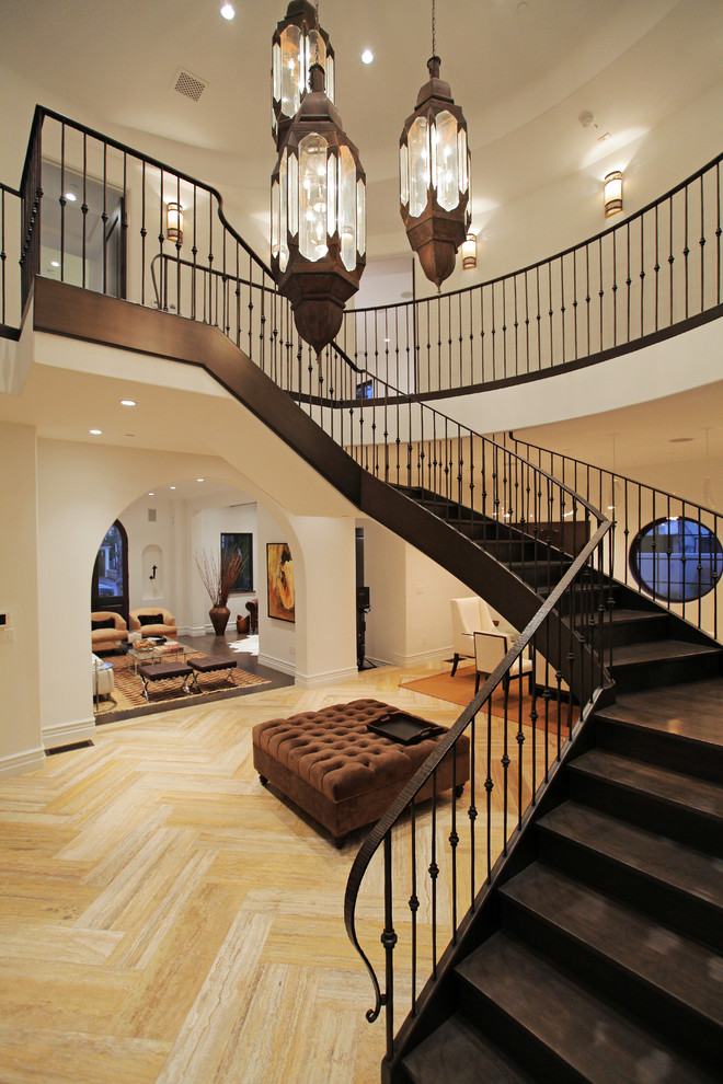 Design ideas for a large contemporary wood curved staircase in Los Angeles with wood risers.