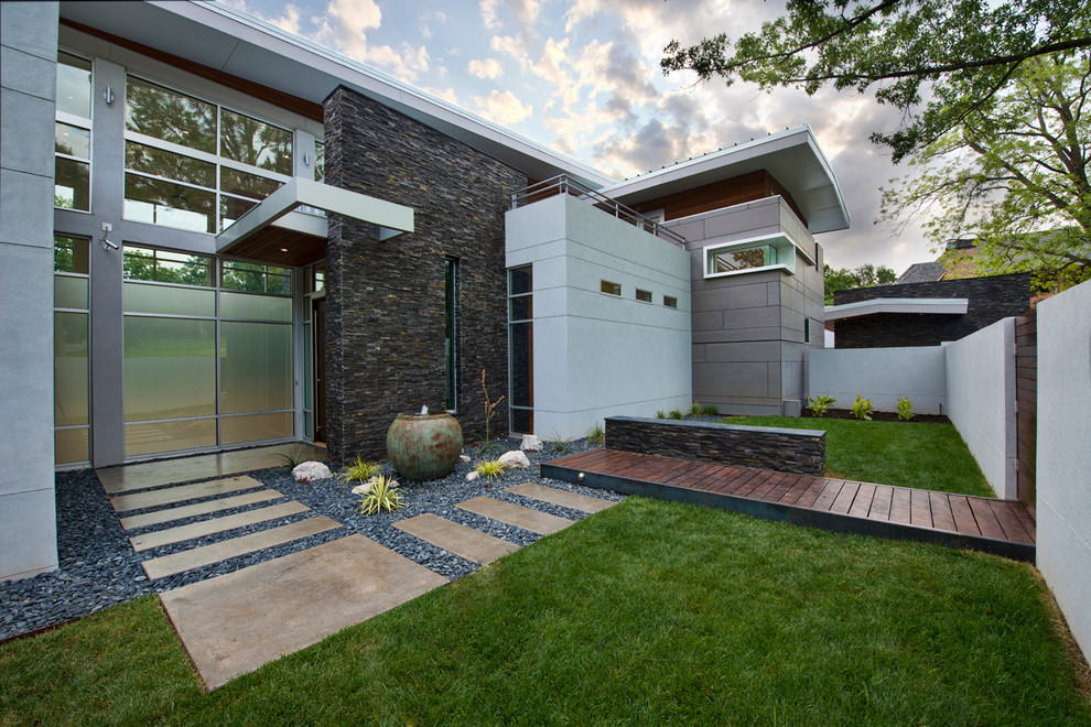 This is an example of a large contemporary two-storey grey exterior in Other with mixed siding.