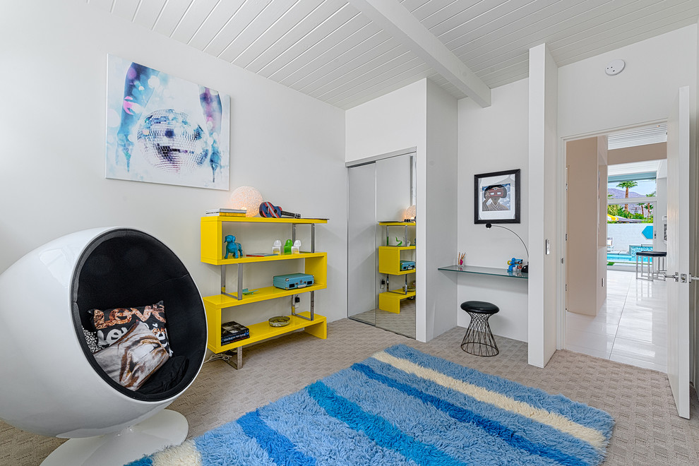 Midcentury gender-neutral kids' playroom in Los Angeles with white walls and carpet.