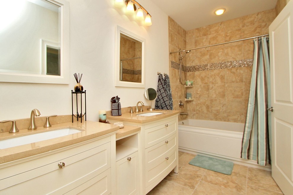 Photo of a mid-sized transitional master bathroom in Orange County with furniture-like cabinets, white cabinets, a corner tub, a shower/bathtub combo, white walls, ceramic floors, an undermount sink and solid surface benchtops.