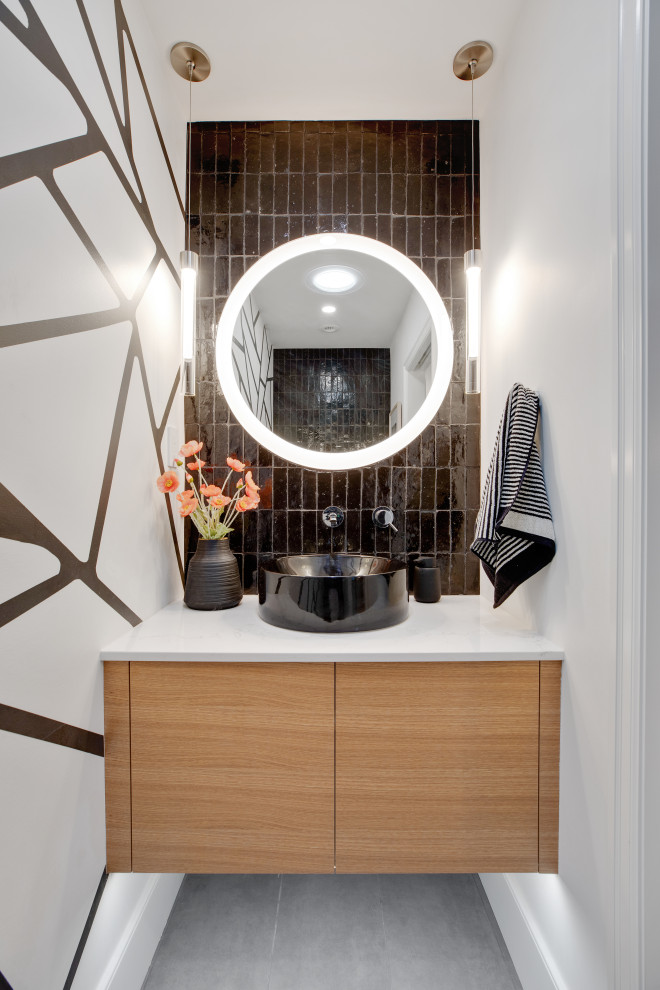 Small retro cloakroom in Portland with light wood cabinets, a one-piece toilet, black tiles, ceramic tiles, white walls, ceramic flooring, a vessel sink, engineered stone worktops, grey floors, white worktops and a floating vanity unit.