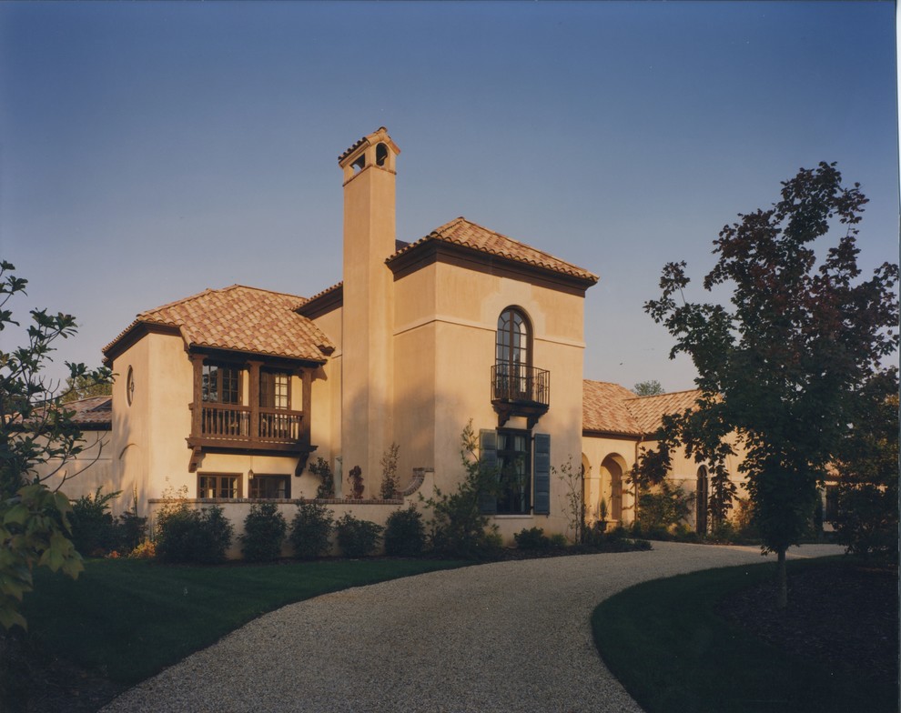 Inspiration for a traditional two-storey adobe beige exterior in Charlotte.