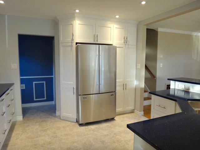 Inspiration for a large transitional u-shaped eat-in kitchen remodel in Toronto with recessed-panel cabinets, white cabinets, quartzite countertops, white countertops, an undermount sink and stainless steel appliances