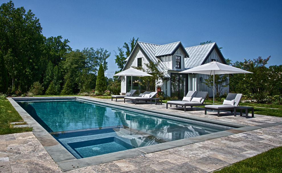 Inspiration for an expansive transitional backyard rectangular lap pool in New York with a pool house and natural stone pavers.