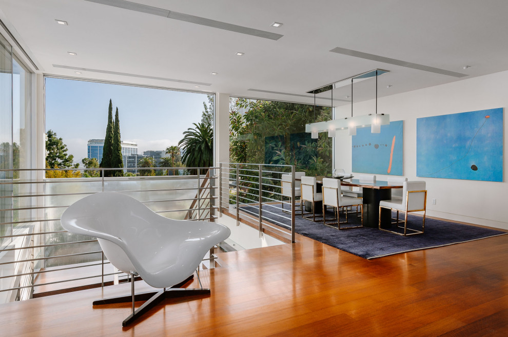 Inspiration for a large modern open plan dining in Los Angeles with white walls and medium hardwood floors.