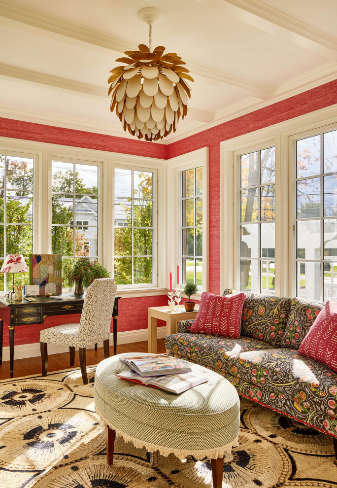 Rye Colonial - Example of a classic freestanding desk medium tone wood floor, brown floor and wallpaper home office design in New York with red walls