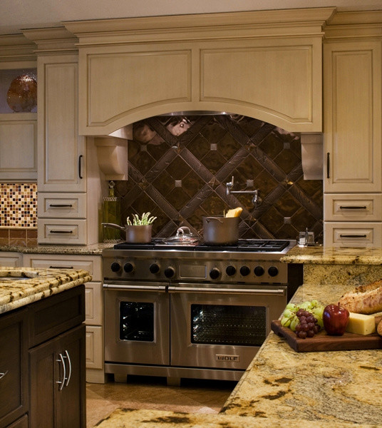 Transitional marble floor kitchen photo in Jacksonville with recessed-panel cabinets, light wood cabinets, granite countertops, multicolored backsplash, ceramic backsplash, stainless steel appliances and two islands