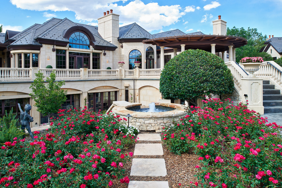 Inspiration for a mediterranean backyard full sun garden in Denver with a water feature and natural stone pavers.