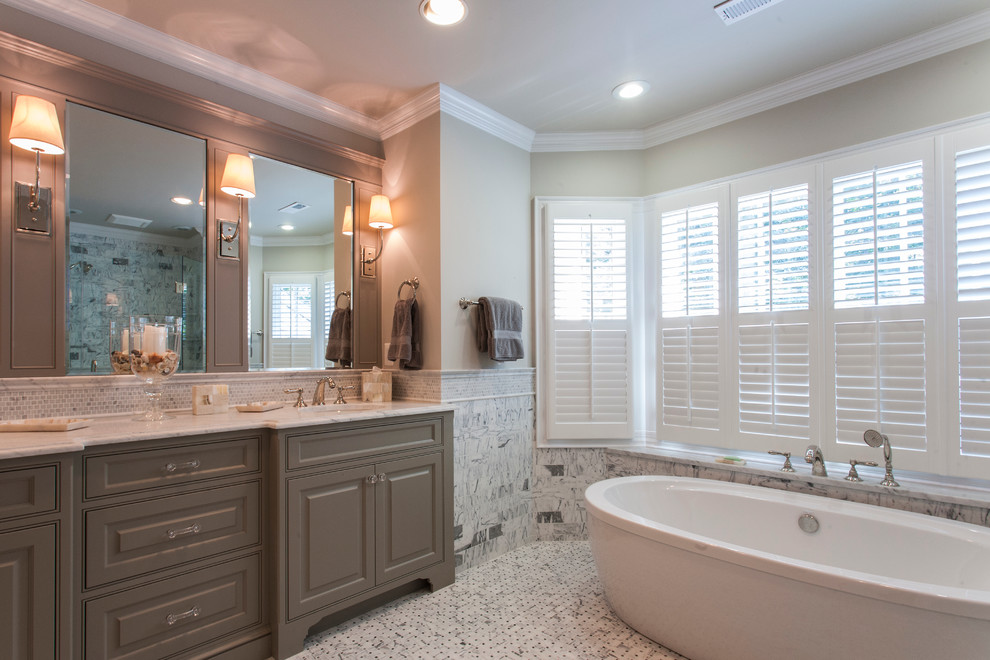 Freestanding bathtub - large transitional master multicolored tile and ceramic tile ceramic tile and gray floor freestanding bathtub idea in DC Metro with an undermount sink, furniture-like cabinets, gray cabinets, marble countertops, a two-piece toilet and gray walls