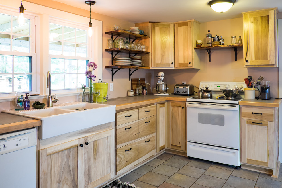 Inspiration for a mid-sized country l-shaped eat-in kitchen in DC Metro with a farmhouse sink, flat-panel cabinets, light wood cabinets, tile benchtops, white appliances, ceramic floors and no island.