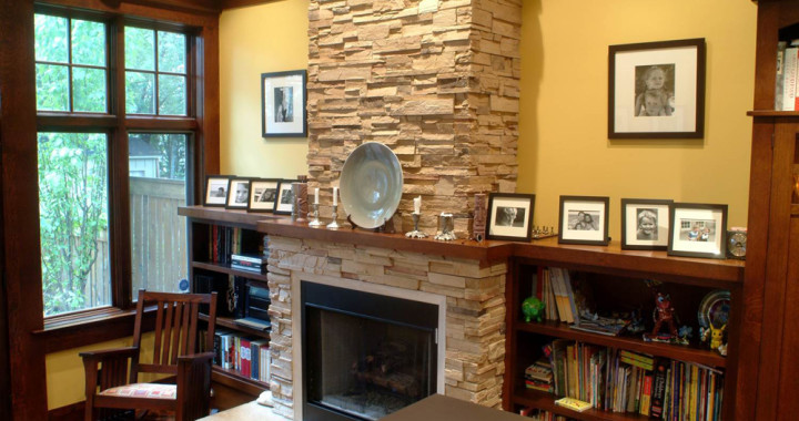 Photo of a mid-sized arts and crafts open concept living room in Toronto with beige walls, slate floors, a standard fireplace and a stone fireplace surround.