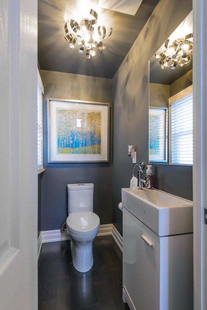 Small transitional dark wood floor powder room photo in Toronto with flat-panel cabinets, white cabinets, a one-piece toilet, gray walls and a trough sink