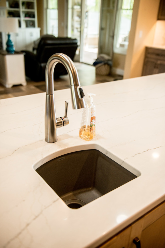 Inspiration for a large transitional l-shaped vinyl floor and multicolored floor open concept kitchen remodel with a farmhouse sink, shaker cabinets, gray cabinets, quartz countertops, white backsplash, subway tile backsplash, stainless steel appliances, an island and white countertops