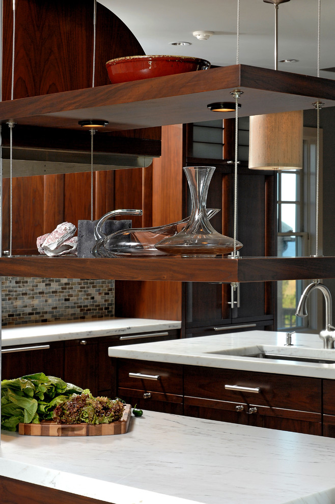 Inspiration for a mid-sized transitional l-shaped light wood floor open concept kitchen remodel in DC Metro with an undermount sink, medium tone wood cabinets, marble countertops, mosaic tile backsplash, paneled appliances and an island