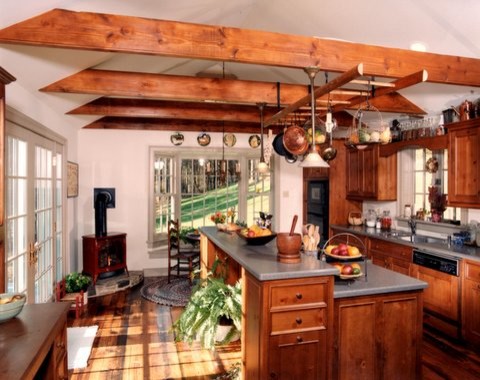Inspiration for a mid-sized traditional eat-in kitchen in Philadelphia with medium wood cabinets, solid surface benchtops, medium hardwood floors and with island.