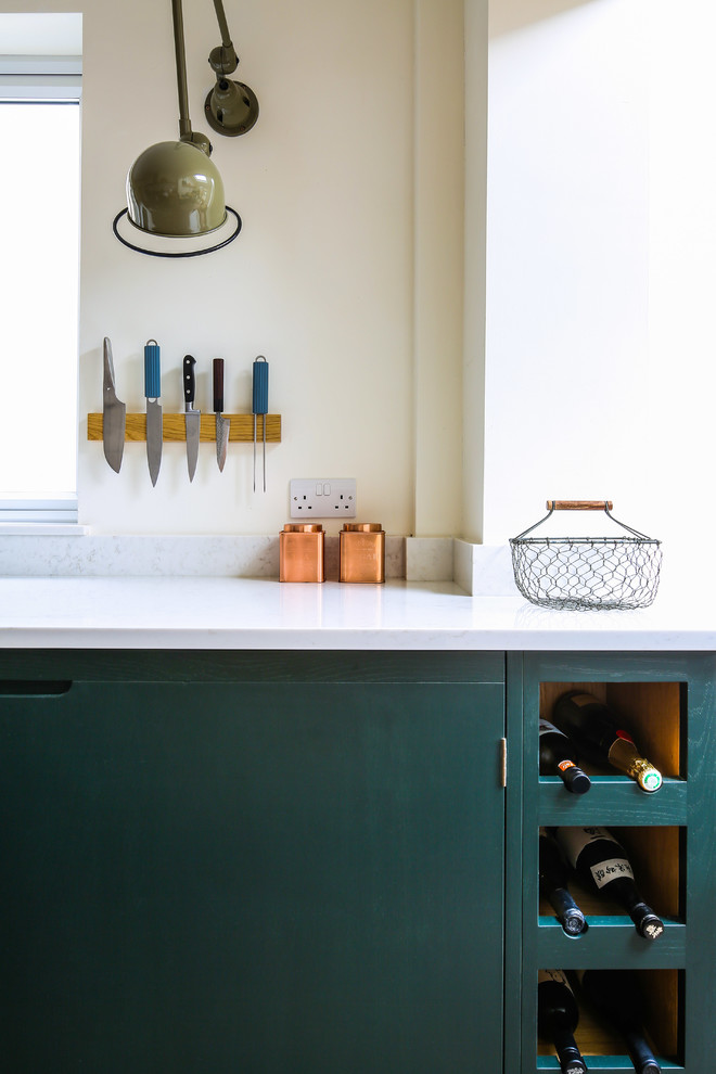 Inspiration for a mid-sized contemporary galley separate kitchen in Other with flat-panel cabinets, green cabinets, wood benchtops, white splashback, subway tile splashback, stainless steel appliances, no island, multi-coloured floor and a single-bowl sink.