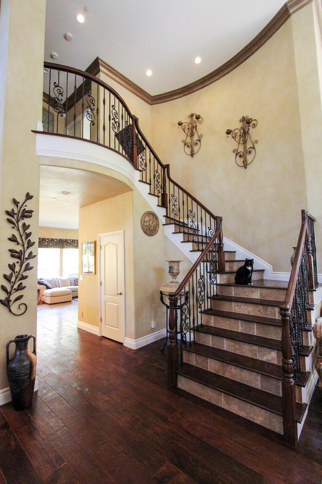Design ideas for a large traditional wood curved staircase in San Francisco with tile risers.