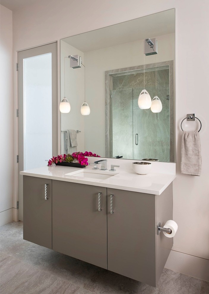Photo of a mid-sized contemporary 3/4 bathroom in Dallas with grey cabinets, gray tile, an undermount sink, engineered quartz benchtops, flat-panel cabinets, an alcove shower, a one-piece toilet, white walls, travertine floors, beige floor and a hinged shower door.