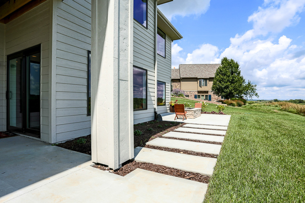 Inspiration for a transitional one-story mixed siding landscaping in Omaha with a hip roof and a shingle roof.