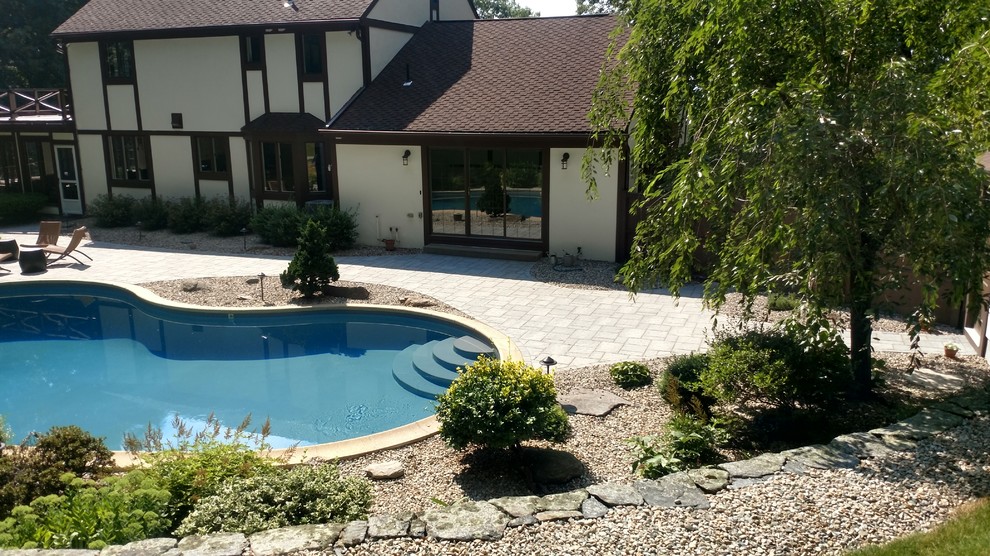Inspiration for a mid-sized full sun backyard concrete paver landscaping.
