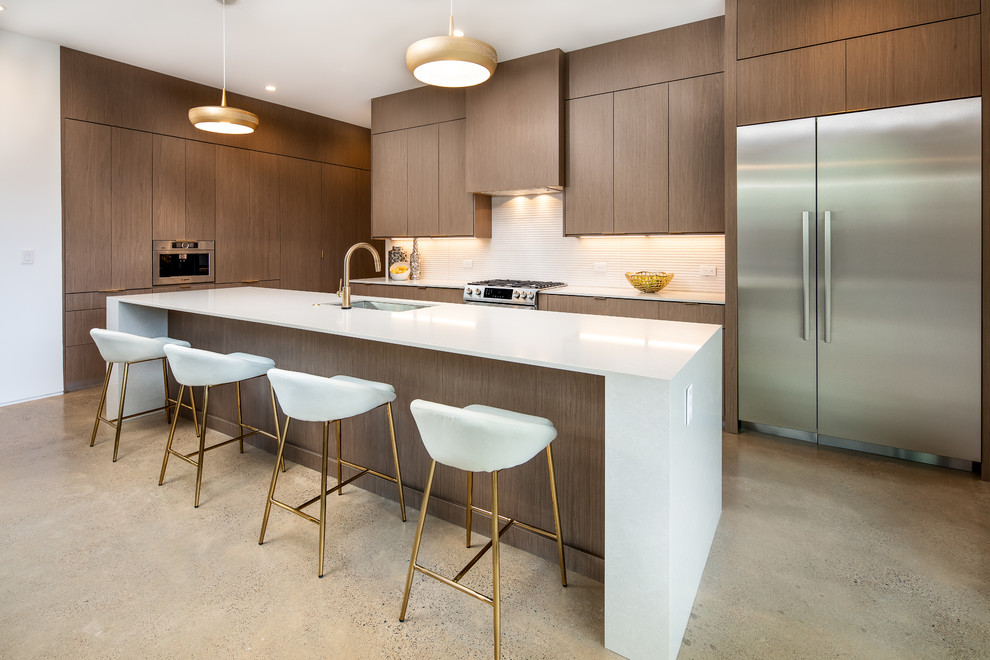 Design ideas for a large contemporary l-shaped open plan kitchen in Dallas with an undermount sink, flat-panel cabinets, white splashback, with island, white benchtop, dark wood cabinets, stainless steel appliances, concrete floors, grey floor and quartz benchtops.