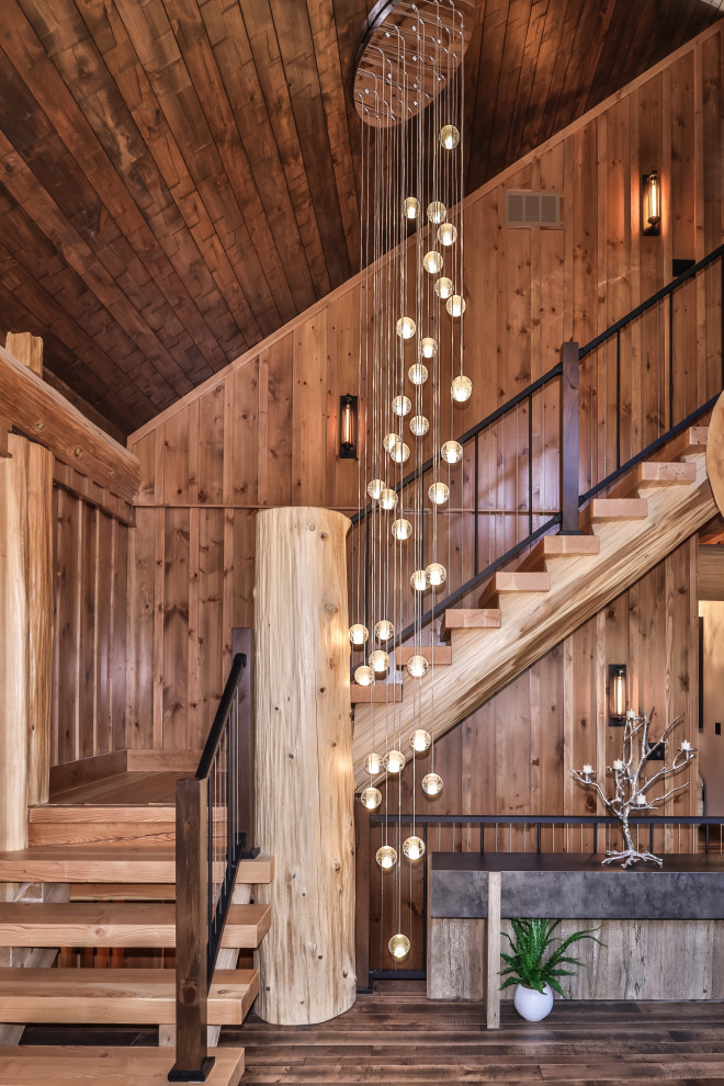 Example of a mid-sized mountain style wooden l-shaped open, mixed material railing and wood wall staircase design