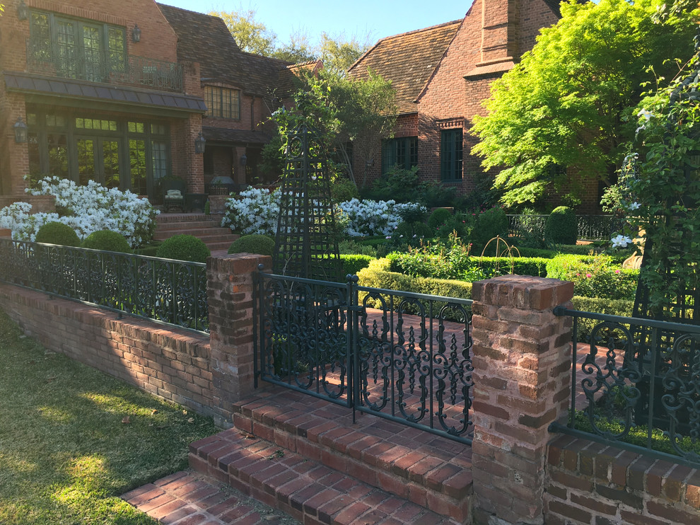 Inspiration for an expansive traditional backyard partial sun formal garden in Dallas with brick pavers and with raised garden bed.
