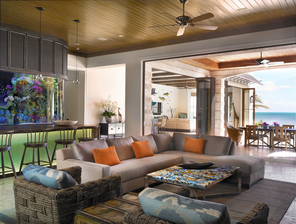 Tropical open concept family room in Miami.