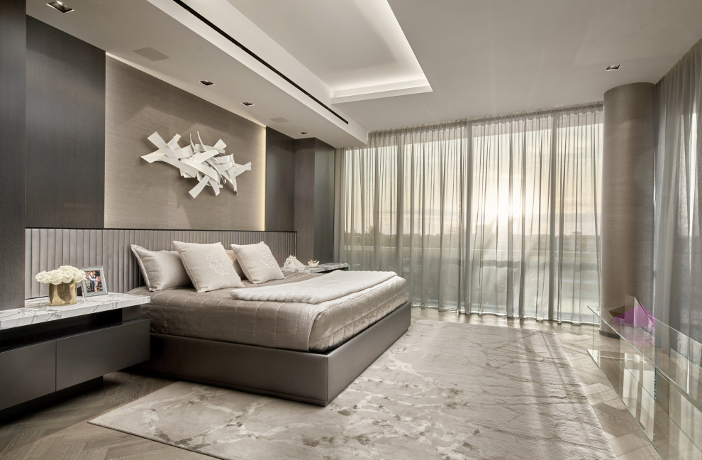 Contemporary bedroom in Miami with grey walls, grey floor and recessed.