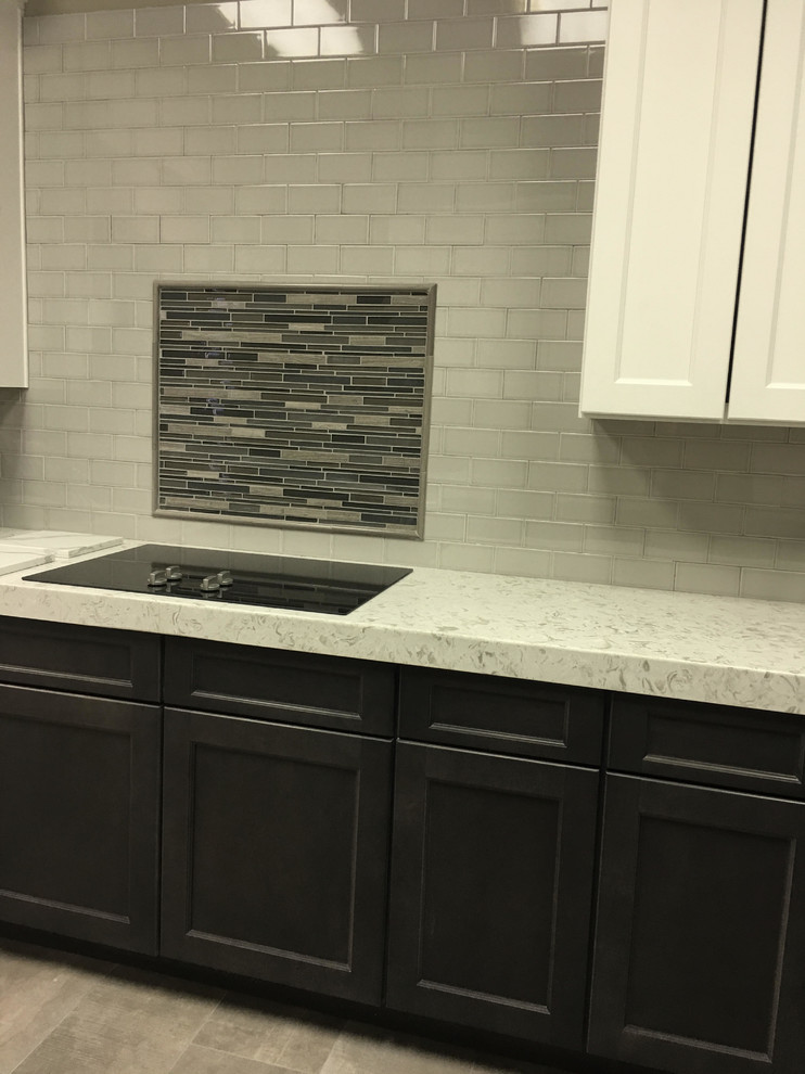 Example of a mid-sized transitional l-shaped porcelain tile enclosed kitchen design in Austin with raised-panel cabinets, dark wood cabinets, granite countertops, beige backsplash, stone tile backsplash, stainless steel appliances and no island