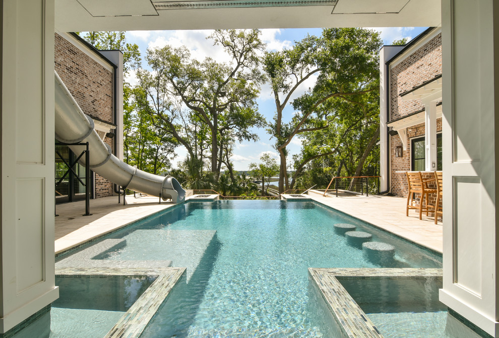Photo of a transitional courtyard custom-shaped lap pool in Charleston with a water slide.