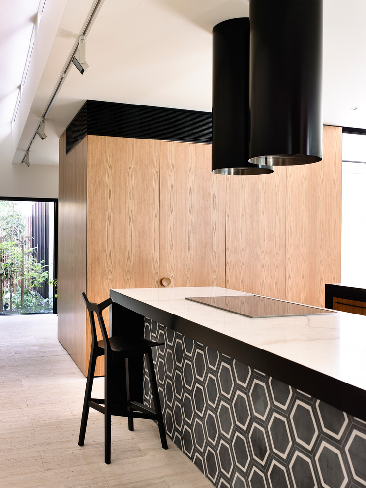This is an example of a large contemporary kitchen in Melbourne with marble benchtops and with island.