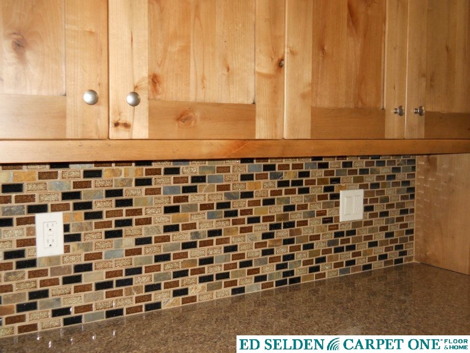 Example of a transitional kitchen design in Seattle with light wood cabinets, quartz countertops, shaker cabinets, multicolored backsplash and glass tile backsplash