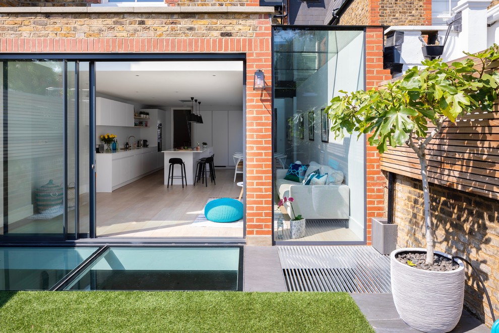 This is an example of a mid-sized contemporary backyard patio in London.