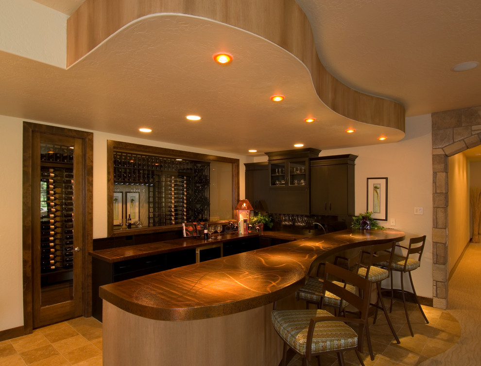 Design ideas for a large contemporary u-shaped seated home bar in Denver with an undermount sink, flat-panel cabinets, dark wood cabinets, copper benchtops, travertine floors and brown floor.