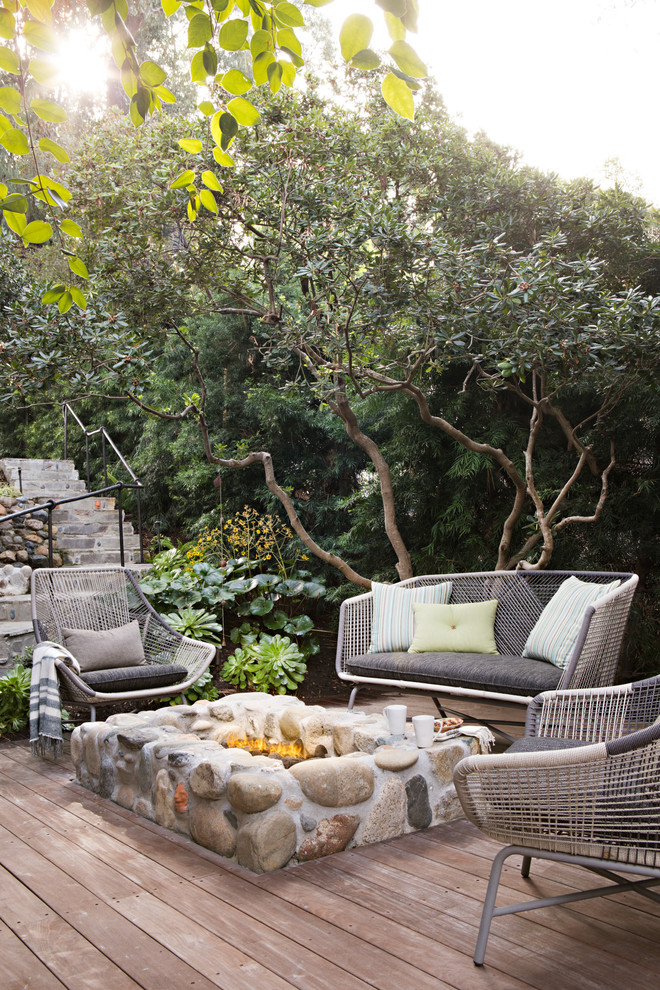 Inspiration for a beach style deck in Orange County with a fire feature and no cover.