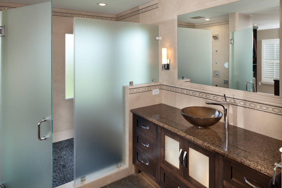 This is an example of a small contemporary master bathroom in DC Metro with a vessel sink, dark wood cabinets, granite benchtops, beige walls, shaker cabinets, gray tile, pebble tile and slate floors.
