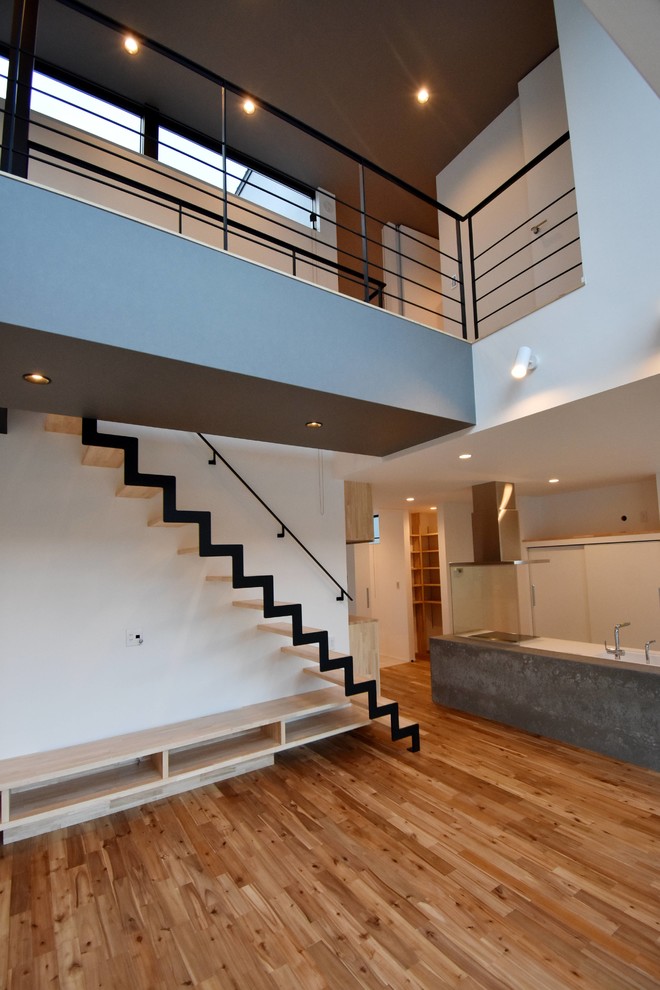 Design ideas for a mid-sized industrial wood straight staircase in Other with open risers and metal railing.
