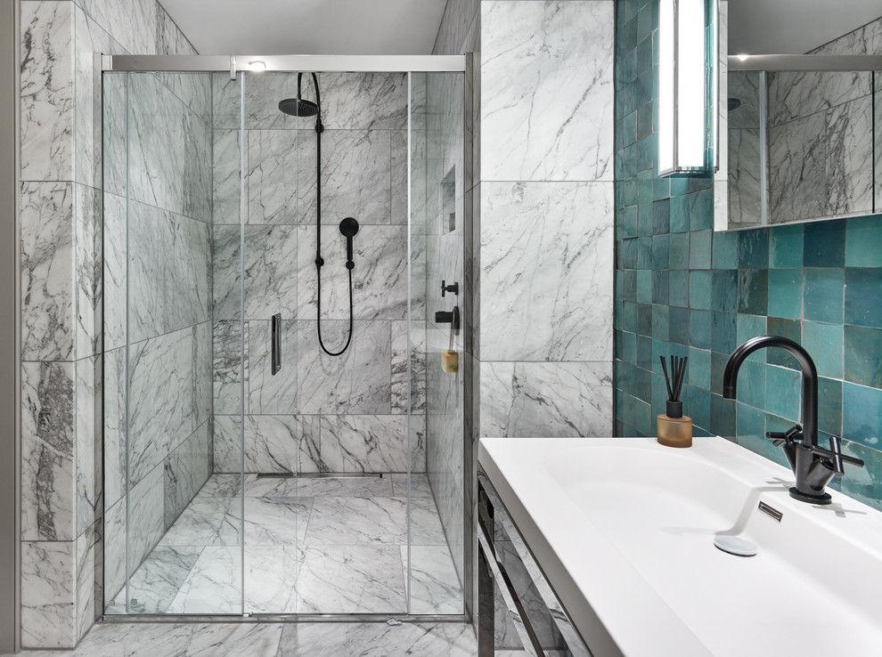 Inspiration for a mid-sized contemporary master bathroom in London with open cabinets, an alcove shower, a one-piece toilet, white tile, marble, blue walls, marble floors, a console sink, solid surface benchtops, white floor and a sliding shower screen.