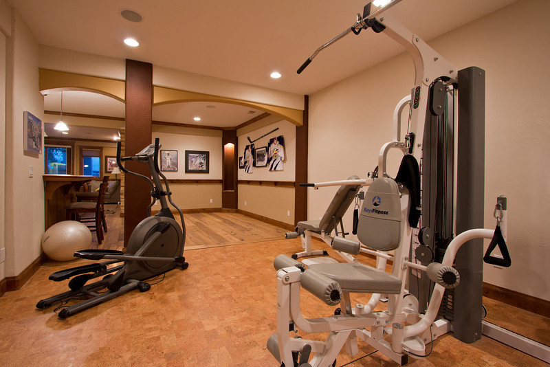 Photo of a mid-sized transitional multipurpose gym in Denver with multi-coloured walls and cork floors.